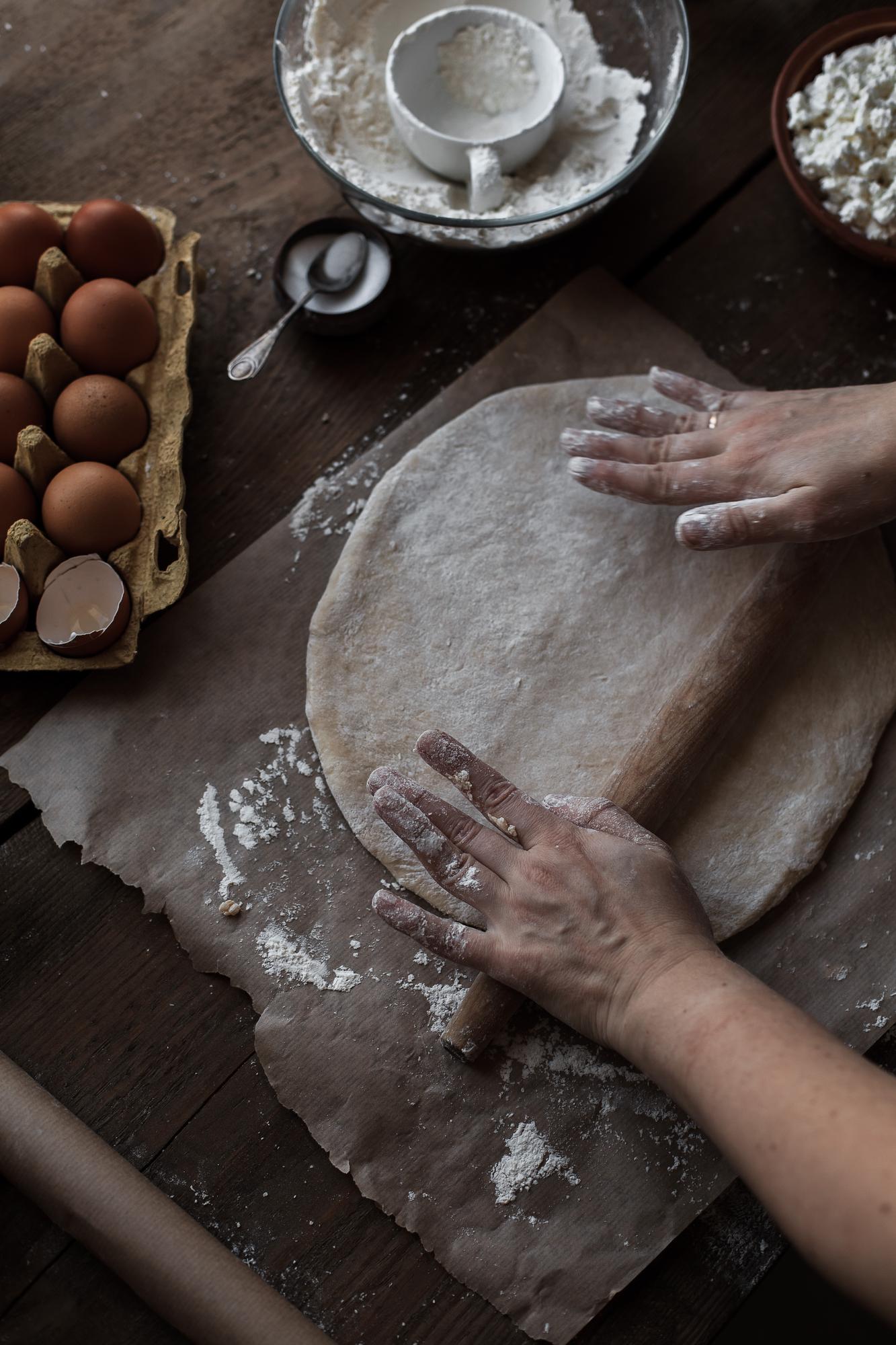 Close-up of hands kneading dough in rustic kitchen